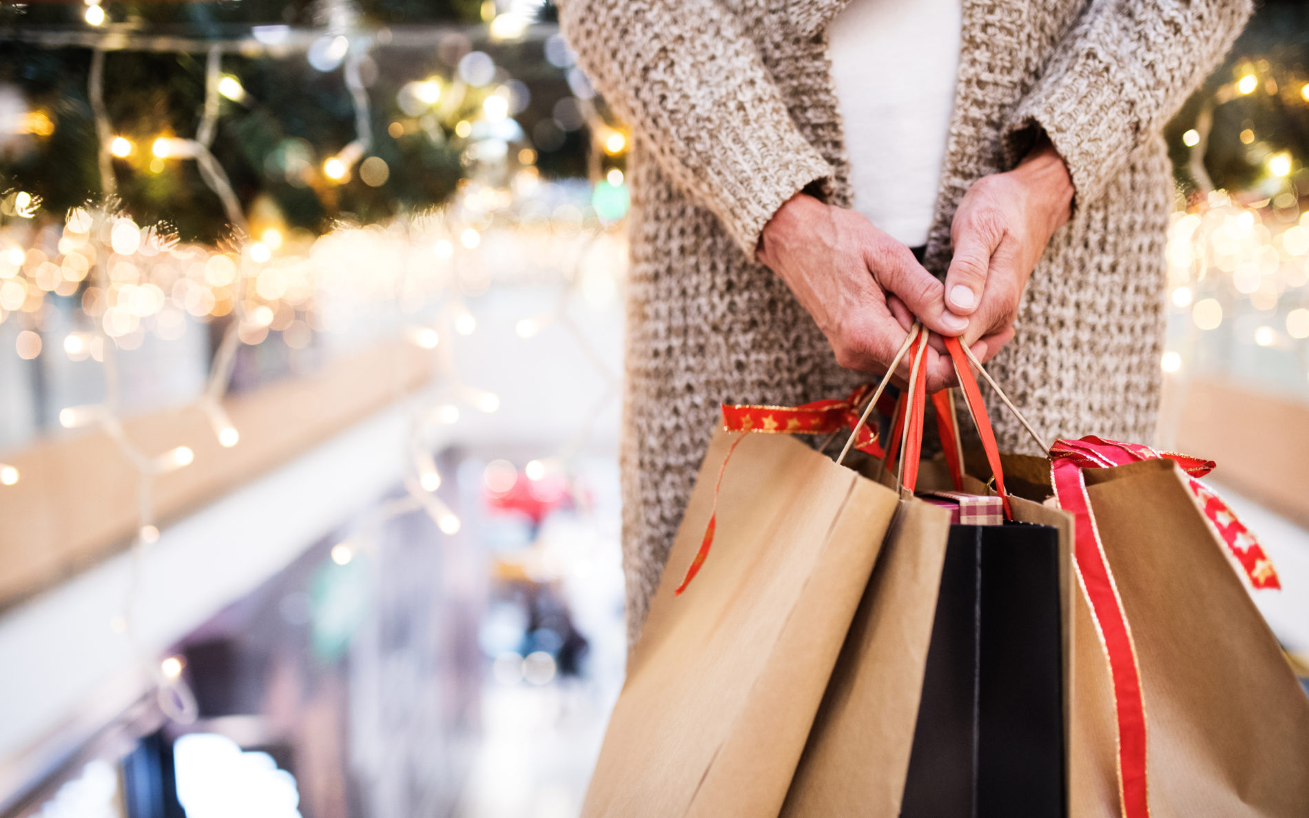 Senior woman at shopping center during the holidays.