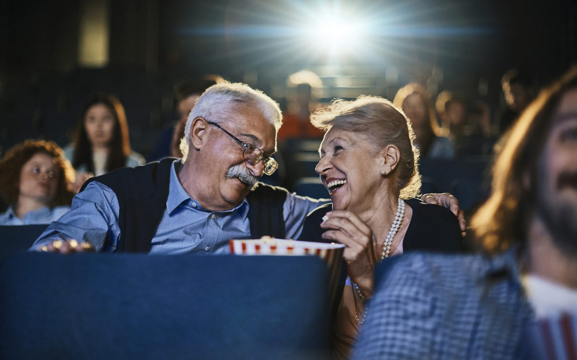 Close up of a senior couple enjoying a movie in the cinema
