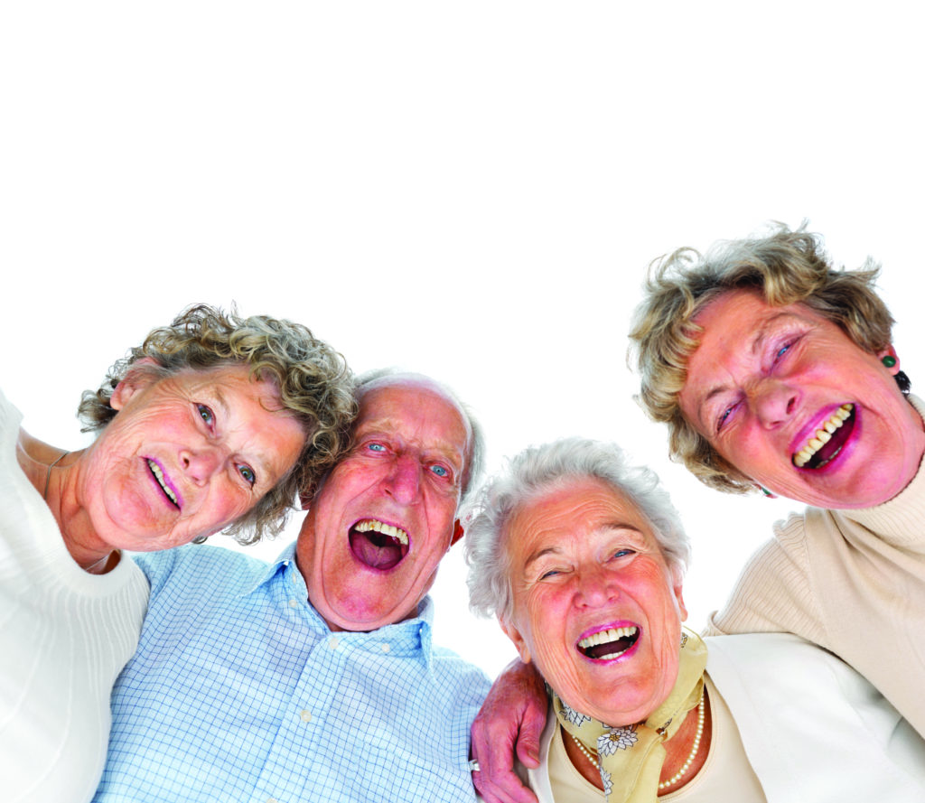 Four residents laughing and smiling while looking down at the camera