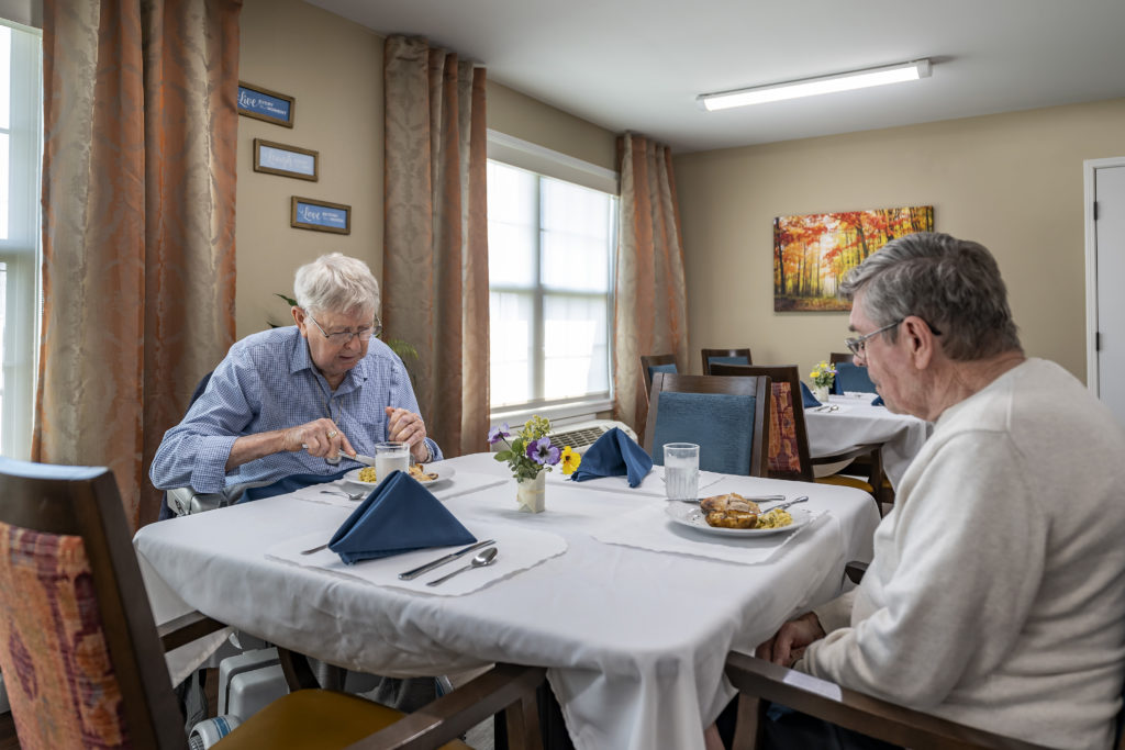 Senior men eating at table