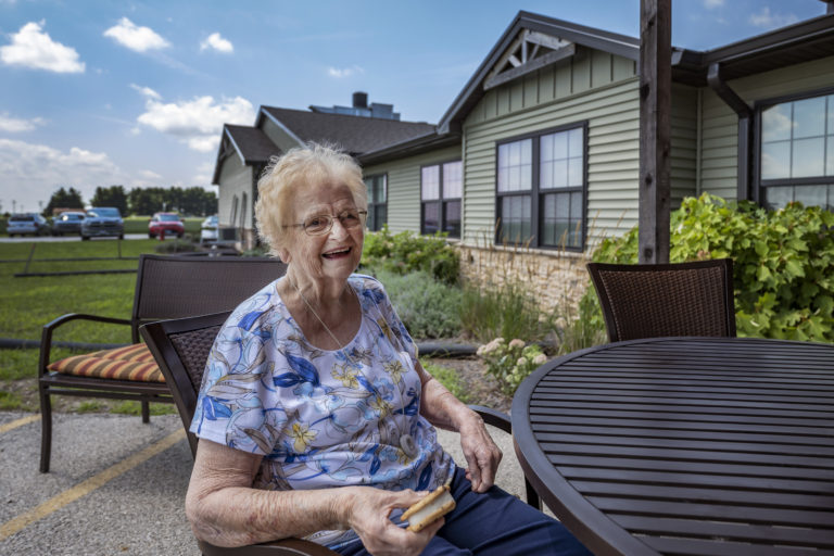 Senior woman sitting at table outside
